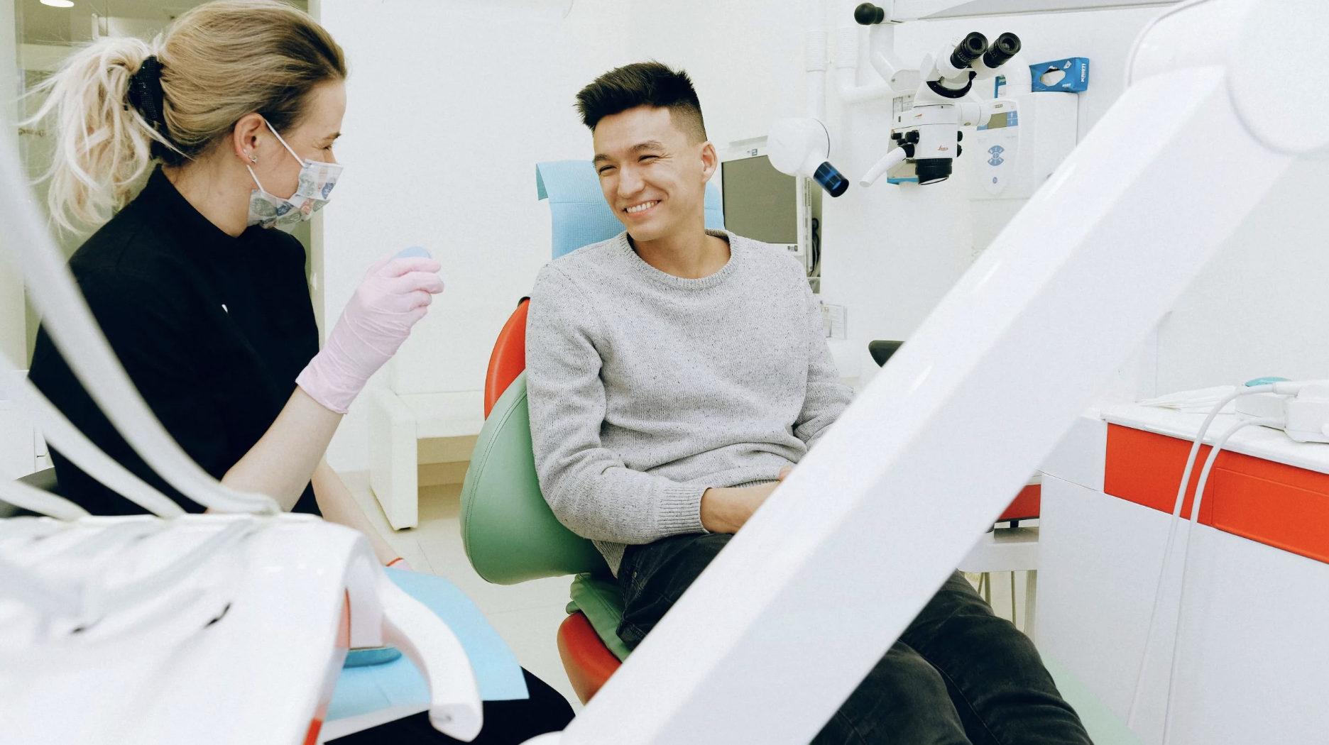 A Nurse speaks with a patient in a doctors office.